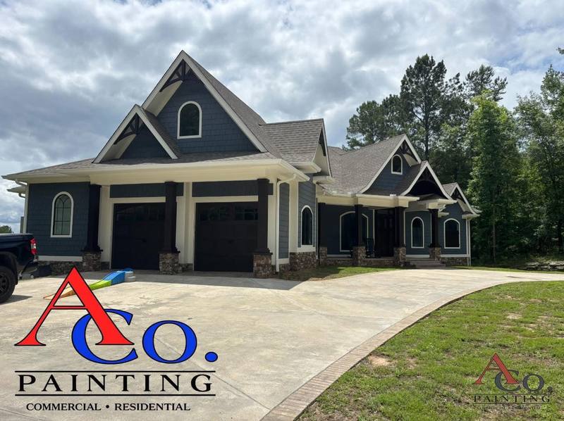 Exterior repaint of a residential home in Meridian, MS with fresh siding, trim, and accent colors